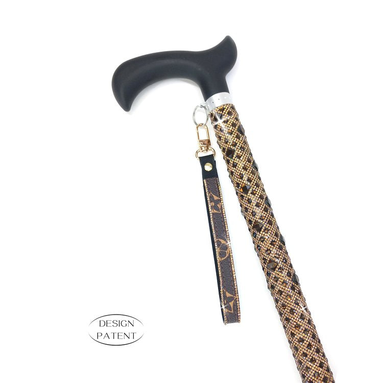 The Jacqueline Kent Sugar Cane is designed as a straight style adjustable medical grade adjustable cane with a comfortable sturdy resin handle.  The adjustable shaft measures 7/8" diameter and adjusts 29" to 38" with locking nut for safety.  Lower shaft measures 3/4" diameter including a rubber foot.  Each cane supports up to 250 pounds.  Each handcrafted Sugar Cane is embellished with approximately 5000 rhinestones and includes a black velvet tote bag.