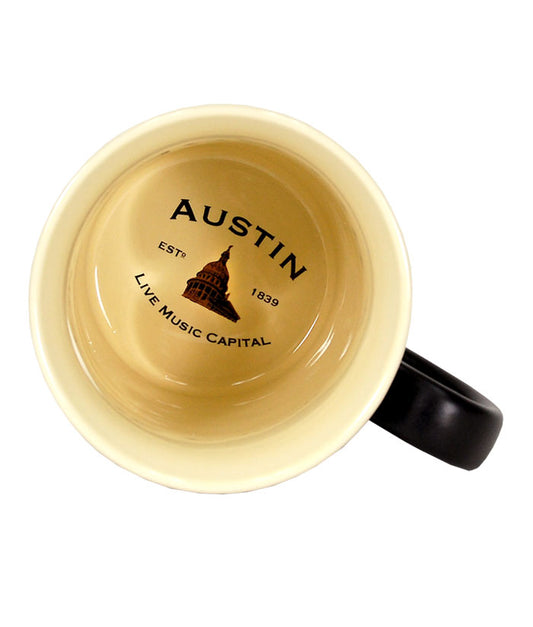 This generously sized two tone ceramic stein style mug, features a beautiful black matte exterior and contrasting tan interior inspired by the “black and tans” served in old time Irish pubs. The raised emblem features popular Austin Icons.