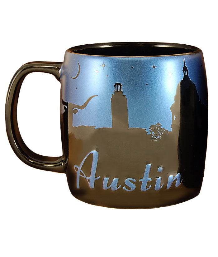 Enjoy your favorite hot beverage with this generously sized black Night Sky Mug. Features a metallic blue night sky with iconic silhouettes of your favorite Austin locations. Microwave and dishwasher safe. Holds 20 ounces