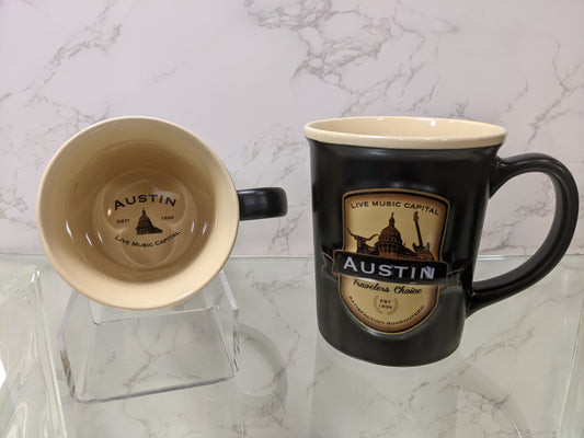 This generously sized two tone ceramic stein style mug, features a beautiful black matte exterior and contrasting tan interior inspired by the “black and tans” served in old time Irish pubs. The raised emblem features popular Austin Icons.
