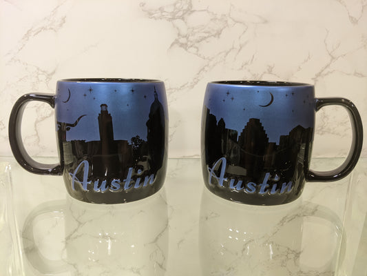 Enjoy your favorite hot beverage with this generously sized black Night Sky Mug.  Features a metallic blue night sky with iconic silhouettes of your favorite Austin locations. Microwave and dishwasher safe. Holds 20 ounces