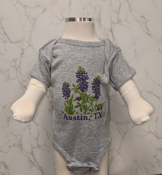 Adorable grey heather onesie with Bluebonnets and Austin, Texas letters.  Designed and printed in the USA. Machine wash in cold water.  Available in newborn and 6 month sizes.